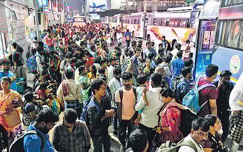 Ahead of poll day in TG and AP, people wait to board a bus at the KPHB bus stand in Hyderabad on Saturday 