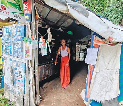 Manichettan in front of his shop