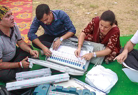 Polling officials check EVMs and other election materials before leaving for their respective polling booths, on the eve of the sixth phase of Lok Sabha polls, at a distribution center, in Gurugram, Friday, May 24, 2024. 