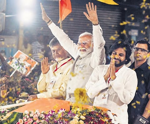 PM Narendra Modi, along with TDP supremo N Chandrababu Naidu and Jana Sena chief Pawan Kalyan, at a roadshow in Vijayawada on Wednesday
