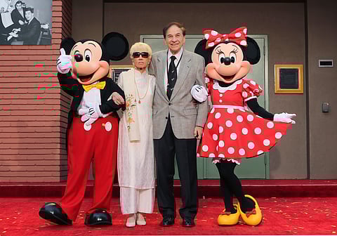 Mickey Mouse, from left, Elizabeth Gluck, Richard M. Sherman and Minnie Mouse pose for a photo at the ceremony honoring the Sherman Brothers with the rename of Disney Studios Soundstage A at the world premiere of Disney's "Christopher Robin" at the Walt Disney Studios, July 30, 2018, in Burbank, Calif.