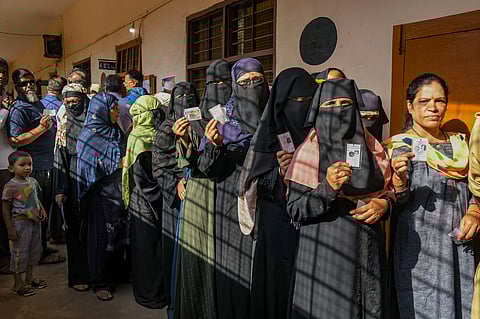 People wait in queues to cast their votes at a polling station during the 3rd phase of Lok Sabha polls, in Karnataka, Tuesday, May 7, 2024. 