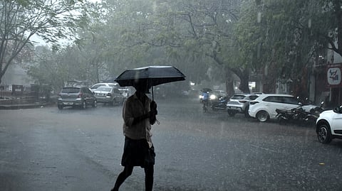 A man covering himself from a heavy rain. 
