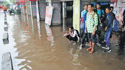 Passengers waiting at the Ernakulam KSRTC bus station during the heavy downpour on Thursday 