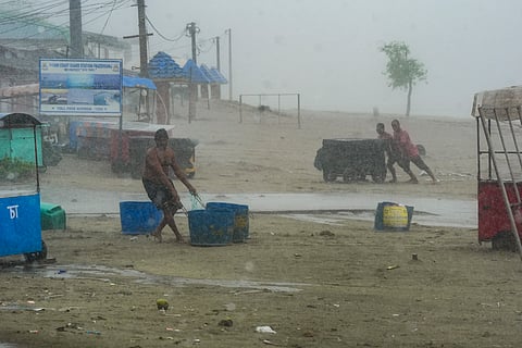 People move their belongings away from the seashore amid rain, ahead of the landfall of Cyclone 'Remal', in South 24 Parganas district, Sunday, May 26, 2024.
