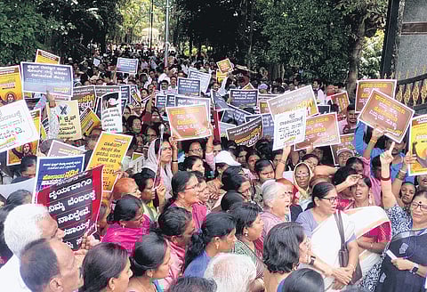 Activists take out a protest rally against Member of Parliament Prajwal Revanna, in Hassan on Thursday