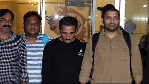 Mumbai Police Crime Branch team brings Bhavesh Bhinde (in black cloth), an accused in the Ghatkopar hoarding collapse case, from Udaipur, at the Mumbai Airport on Thursday late night, May 16, 2024. 