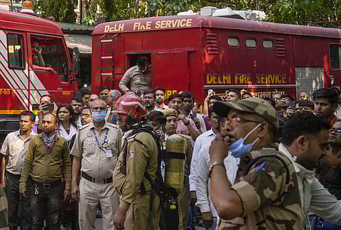 Firefighting team outside the Income Tax CR Building after a fire broke out here, in ITO area of New Delhi, Tuesday, May 14, 2024.