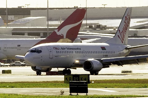 An Air Vanuatu plane makes an emergency landing at Sydney Airport, August 2, 2001, after suspected under carriage damage. 
