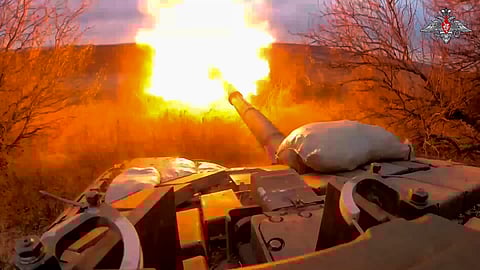 A Russian tank fires at Ukrainian troops from a position near the border with Ukraine in Russia’s Belgorod region. 