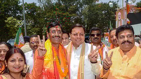  BJP candidate from Ranchi constituency Sanjay Seth with Uttarakhand Chief Minister Pushkar Singh Dhami during a rally after filing his nominations for Lok Sabha elections, in Ranchi.