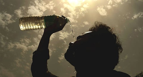 Representational image of a man splashing water on his face on a hot summer day amid heatwave.