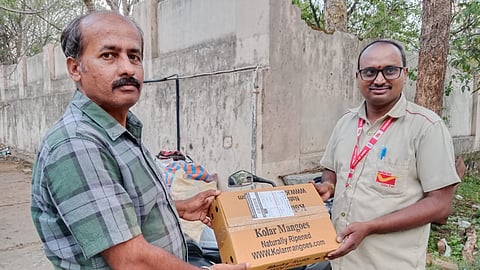 Shot of postal delivery staff delivering mangoes at the doorstep of people at HSR Layout in Bengaluru.