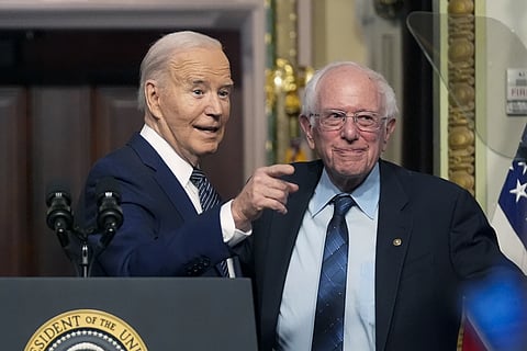 President Joe Biden stands with Sen. Bernie Sanders, after speaking about lowering health care costs in the Indian Treaty Room at the Eisenhower Executive Office Building on the White House complex in Washington, Wednesday, April 3, 2024.