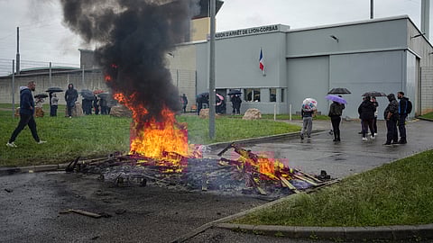 Prison workers gather during a protest outside the Corbas prison, outside Lyon, France, Wednesday, May 15, 2024.