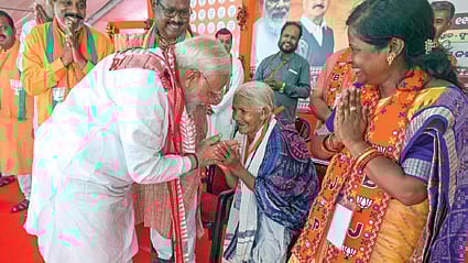 PM Narendra Modi takes the blessings of Padma Shri Purnamasi Jani during his election rally in Phulbani on Saturday