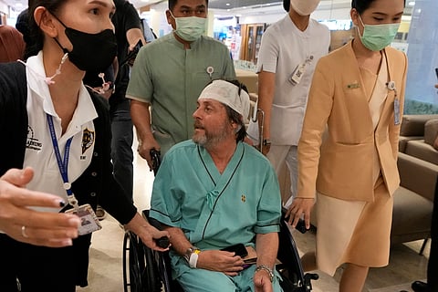 An Australian passenger who was injured on a flight that was battered by severe turbulence, talks to reporters at Samitivej Srinakarin Hospital in Bangkok, Thailand, Thursday, May 23, 2024. 
