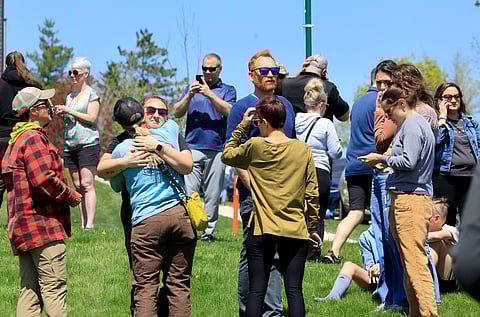 People gather at a site designated for parent and student reunifications following a report of a armed person outside Mount Horeb Middle School in Mount Horeb