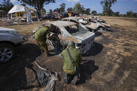 Israeli soldiers inspect the site of the Nova music festival where at least 260 Israeli festival-goers were killed during the attack by Hamas militants on Oct 7, near the border with the Gaza Strip in southwestern Israel, Oct 13, 2023.