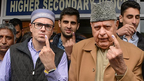 National Conference President Farooq Abdullah, his son and party Vice President Omar Abdullah and grandsons Zamir Abdullah and Zahir Abdullah show their ink marked fingers after casting their votes.