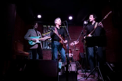 US Secretary of State Antony Blinken, center, performs "Rockin' in the Free World" with members of The 1999 band at the Barman Dictat bar in Kyiv (Photo | AP)
