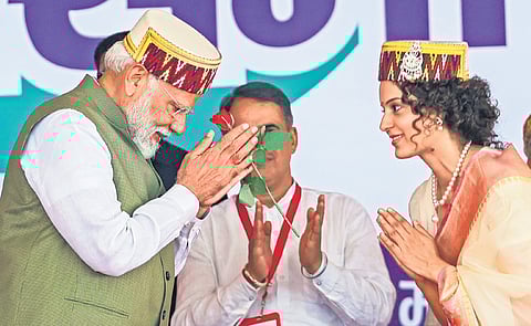 Prime Minister Narendra Modi with BJP’s candidate Kangana Ranaut during an election campaign at Mandi in Himachal Pradesh on Friday.