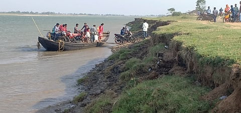 Residents taking boats to ferry across the Subarnarekha river