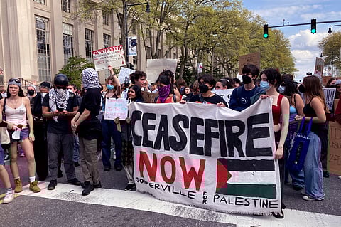 Pro-Palestinian protestors stand on Massachusetts Avenue near a student encampment on the campus of the Massachusetts Institute of Technology.