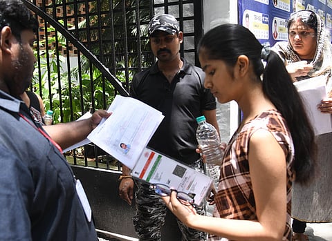 Students arrive to write the NEET examination at Jain College in Bengaluru on Sunday. 