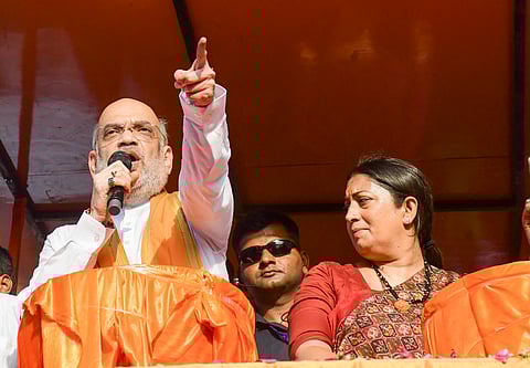 Union Home Minister Amit Shah with Union Minister and BJP candidate from Amethi constituency Smriti Irani and others during an election roadshow for the Lok Sabha polls, in Amethi district, Saturday, May 18, 2024. 