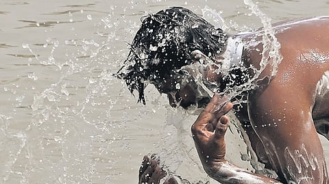 A man takes a bath amid the heatwave in Delhi on Wednesday.