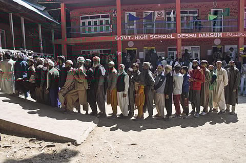 Voters wait in queues to cast their vote for the sixth phase of the Lok Sabha elections, at a polling station, Kokernag, in Anantnag on Saturday.