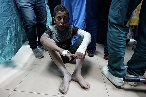 A Palestinian child wounded in the Israeli bombardment of the Gaza Strip waits for the treatment at Al Aqsa hospital in Deir al Balah, central Gaza Strip, on Sunday, May 26, 2024.
