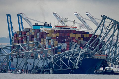 The container ship Dali, owned by Grace Ocean PTE, rests against wreckage of the Francis Scott Key Bridge in the Patapsco River