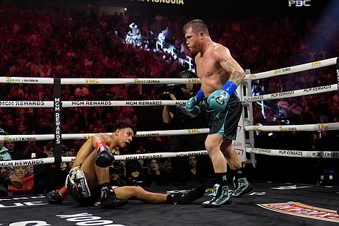 Canelo Alvarez knocks down Jaime Munguia in a super middleweight title fight Saturday, May 4, 2024, in Las Vegas.