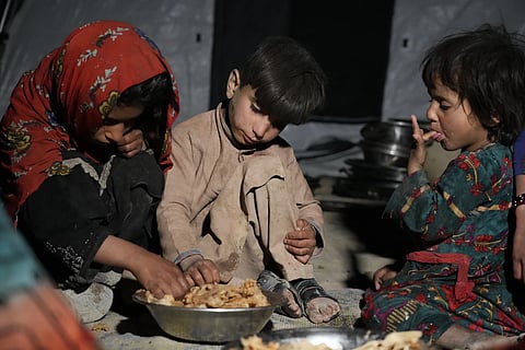 Afghan children eat in a makeshift shelter after an earthquake in Gayan district in Paktika province, Afghanistan, Saturday, June 25, 2022.