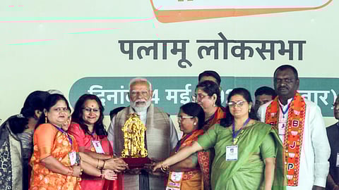 Prime Minister Narendra Modi being felicitated by BJP workers during a public meeting for the Lok Sabha elections, in Palamu district, Saturday, May 4, 2024. 