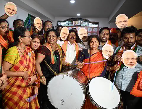 BJP party workers celebrate the Lok sabha poll election results at the state party headquarters in Hyderabad.
