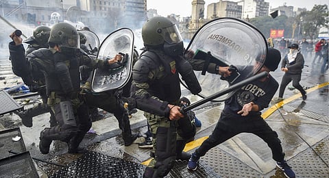 Anti-government protesters clash with police outside Congress, as lawmakers debate a reform bill promoted by Argentine President Javier Milei in Buenos Aires, Argentina, Wednesday, June 12, 2024.