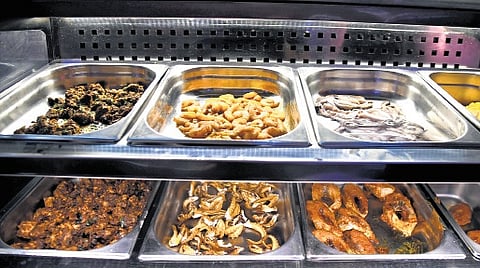 A diverse selection of food counters featuring both non-vegetarian and vegetarian options