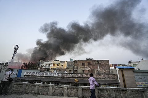 Smoke billows out after a massive fire broke out at Marwadi Katra in Chandni Chowk, Delhi, Thursday, June 13, 2024. 