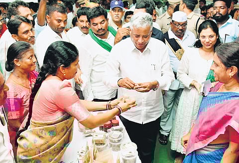 Union Minister of State for Jal Shakti and Railways V Somanna takes a look at products produced by self-help groups at the Krishi Vignana Kendram in Jammikunta.