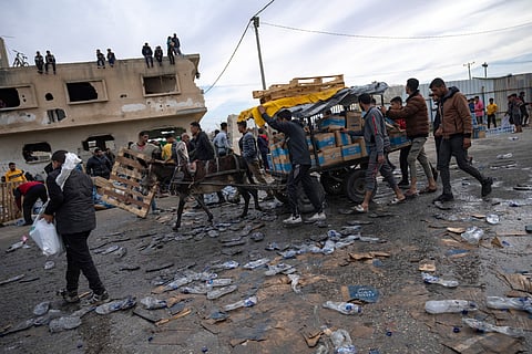 Palestinians gather to fill water jugs near one of the strip's few functioning desalination plants in Deir al-Balah, Gaza Strip.