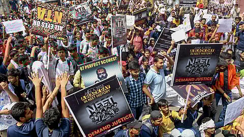 Students stage a protest demanding re-examination of NEET-UG 2024 results outside the Kashi Hindu University, in Varanasi.