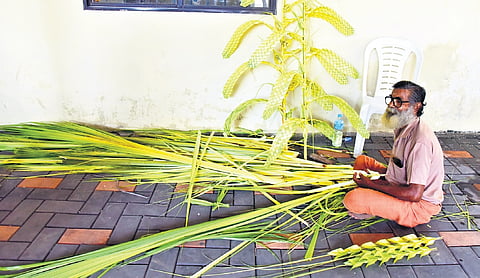 K Parameshwaran crafting sculptures out of kurutholas at Elamakkara Government Higher Secondary School 