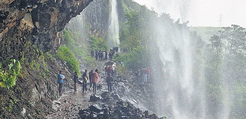 People enjoy Kumbhavade waterfalls near Amboli, Karnataka border