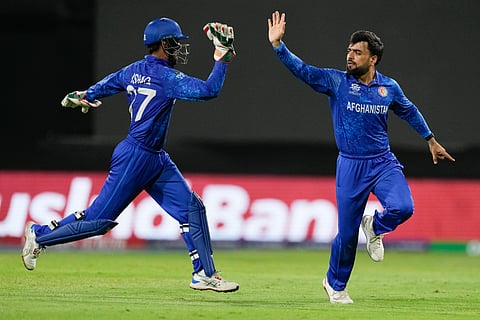 Afghanistan's captain Rashid Khan, right, celebrates with teammate Mohammad Ishaq after dismissing Bangladesh's Soumya Sarkar during the men's T20 World Cup cricket match between Afghanistan and Bangladesh at Arnos Vale Ground, Kingstown, Saint Vincent and the Grenadines, Monday, June 24, 2024.