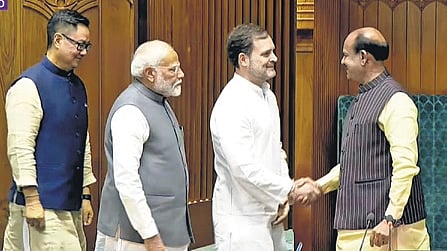 The  Leader of Opposition (LoP) Rahul Gandhi shaking hands with Speaker Om Birla, as Prime Minister Narendra Modi and Parliamentary Affairs Minister Kiren Rijiju stand behind him.