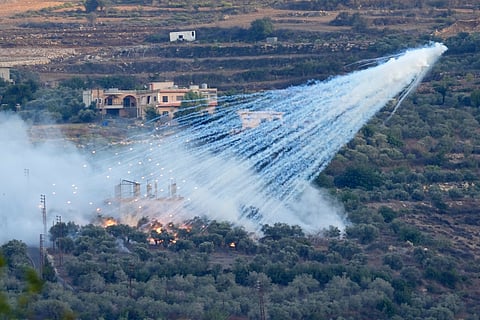 A shell that appears to be white phosphorus from Israeli artillery explodes over a house in al-Bustan, a Lebanese village along the border with Israel, on Oct. 15, 2023. 