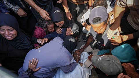 Palestinians mourn a man killed in the Israeli bombardment of the Gaza Strip at a hospital in Deir al Balah on Friday. 